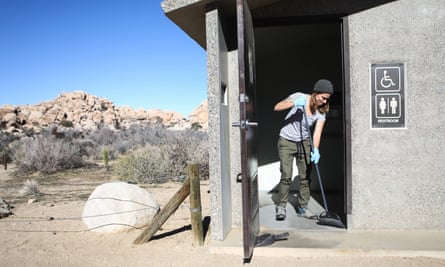 Volunteer Alexandra Degen cleans a restroom at Joshua Tree National Park on 4 January during the government shutdown.