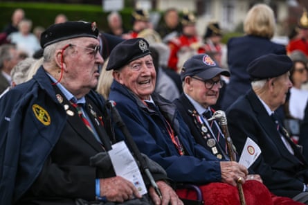 British veterans in uniform at the front of a crowd