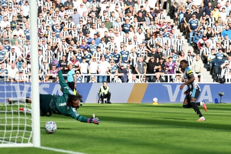 Anthony Elanga of Newcastle United scores his team’s first goal past Alisson Becker of Liverpool.