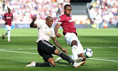 Issa Diop of West Ham United intercepts Ashley Young of Manchester United.