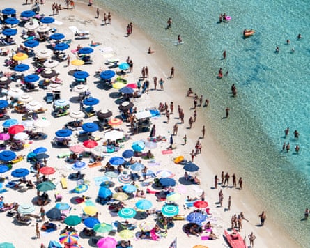 Aerial view of people and umbrellas on a beach