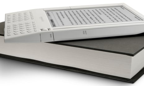 E-reading on top … one of the first Kindles rests on a traditional book.