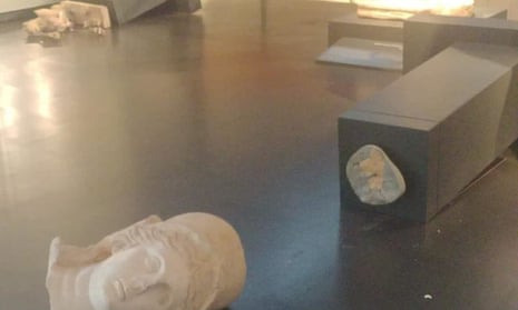 The marble head of a statue of the goddess Athena knocked off its pedestal on to the floor and another shattered statue at the Israel Museum on 5 October 2023
