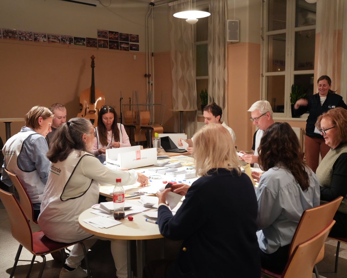 Staff members count ballots at a counting station in Stockholm, Sweden.