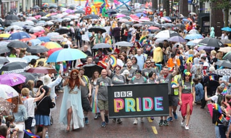 Crowds watch as members of the BBC march for the first time in the Belfast Pride parade.
