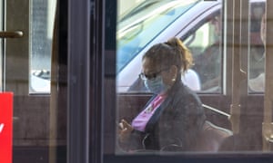 A woman on a London bus wearing a face mask