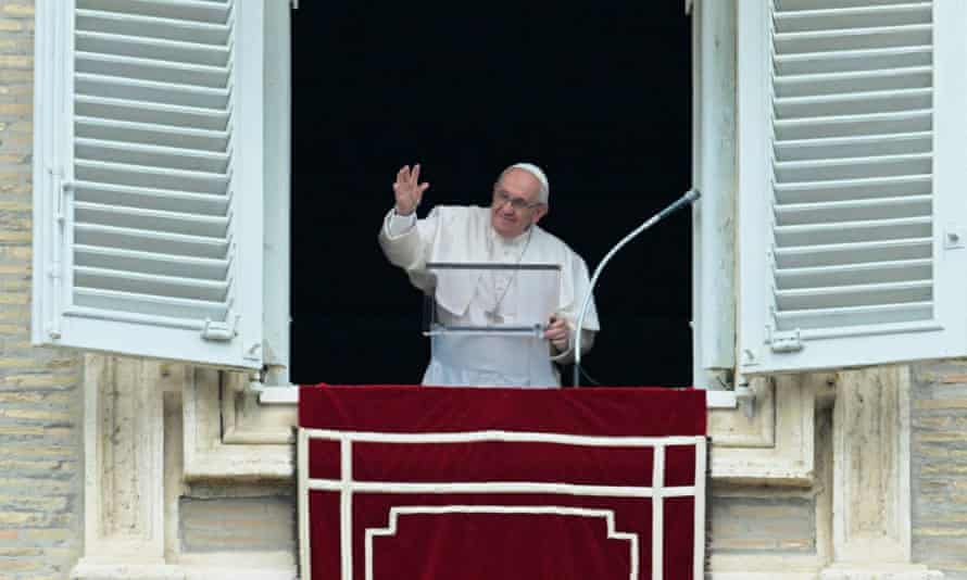 Pope Francis waves prior to deliver his Sunday Regina Coeli prayer from the window of his study overlooking St Peter’ Square at the Vatican.