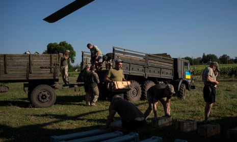 Ukrainian soldiers prepare shells to load on to an attack helicopter in eastern Ukraine.