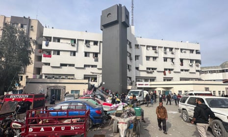 Displaced Palestinians gather outside Gaza's al-Shifa hospital on 10 December 2023.