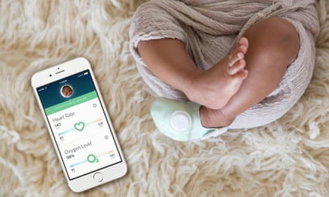 Owlet wearable for baby, pictured with iphon