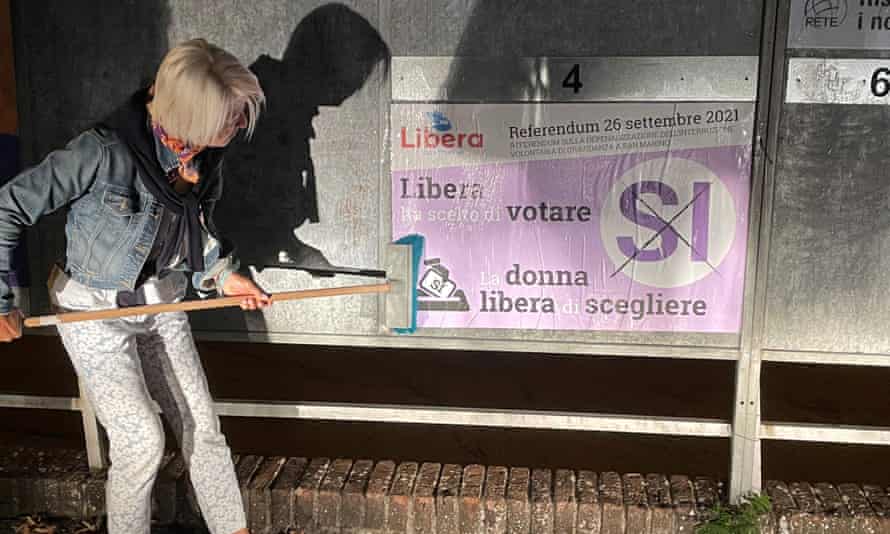 Dr. Francesca Nicolini puts up a pro-abortion poster ahead of the abortion referendum in San Marino.