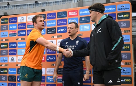 Wallabies captain Harry Wilson and All Blacks skipper Scott Barrett shake hands at the coin toss in front of English referee Matthew Carley.