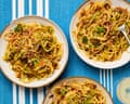 Meera Sodha's sweetheart cabbage and caramelised onion spaghetti on three plates on a blue with white stipe tablecloth.