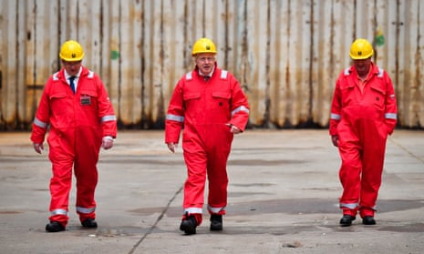 The British prime minister, Boris Johnson (centre), with InfraStrata CEO, John Wood, left, and caretaker Clifford Edwards at the Appledore Shipyard.