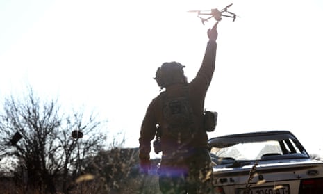 A Ukrainian serviceman of the 1st Independent Tank Brigade releases a drone for take-off near the frontline of Vuhledar.
