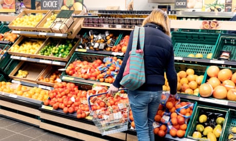 A woman shopping for fruit in Tesco supermarket