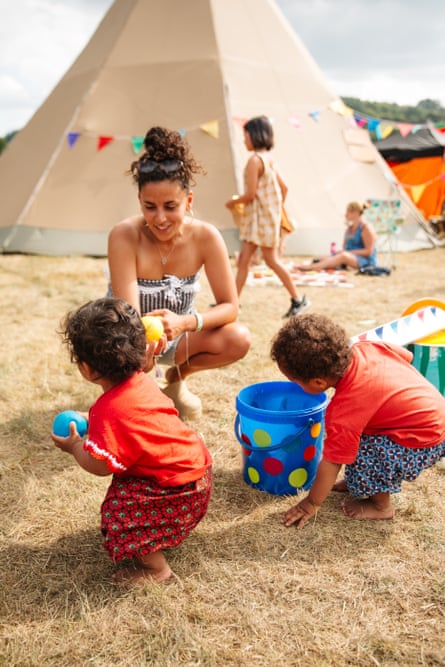 Iman and kids get playing in the fields at Green Man festival.