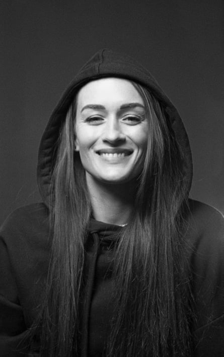 Author Margo Steines smiles while wearing a hoodie.