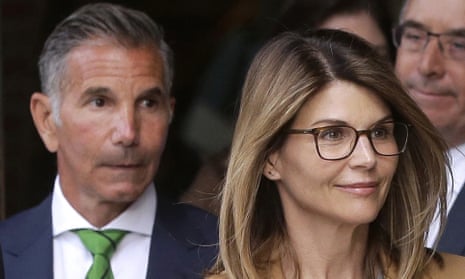 Lori Loughlin, front, and her husband, the clothing designer Mossimo Giannulli, left, depart federal court in Boston last year.