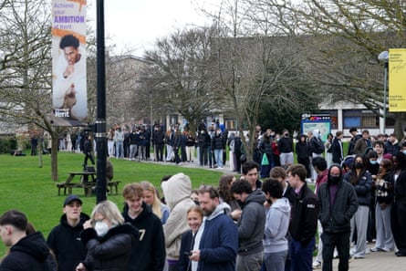 A long line of students on the university campus.