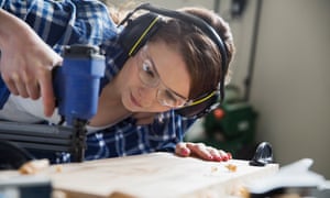 a woman using a drill