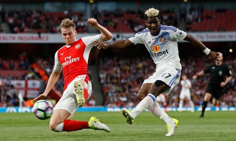 Sunderland’s Didier Ndong shoots at goal past the challenge of Arsenal’s Rob Holding.
