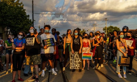 Protesters stand on a road during a march against the shooting of Jacob Blake in Kenosha, Wisconsin, on 27 August.