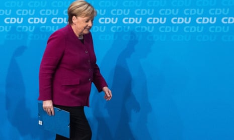 Angela Merkel leaves at the end of a press conference at the CDU headquarters after announcing she will not stand for re-election as chancellor.