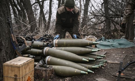 A Ukrainian serviceman prepares 155mm artillery shells