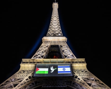 Palestinian (L) and Israeli (R) flags and a dove with an olive olive branch, projected onto the Eiffel Tower on the eve of France's planned recognition of the State of Palestine, in Paris, on September 21, 2025. (Photo by BERTRAND GUAY/AFP via Getty Images)