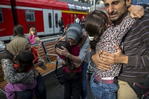 Ihab, a Syrian refugee from Deir ez-Zor, cries as he and his family are hugged by relatives upon arrival at Lubeck railway station in Germany.