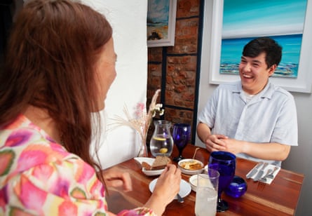 Anna and JJ chatting across a restaurant table