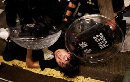 A demonstrator is detained by police officers during a protest in Hong Kong, China August 31, 2019.