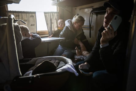 A family sits in a train during an evacuation from Pokrovsk, Donetsk region, 30 November.