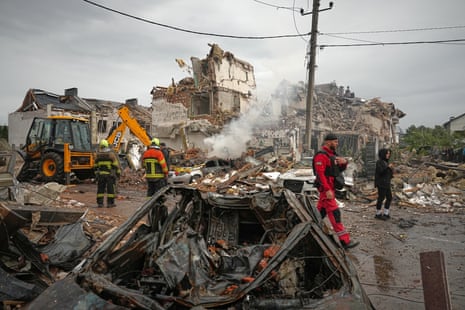 Rescuers work at the site of an apartment buildings damaged during a Russian attack in Kyiv.
