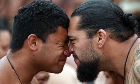 Waka Ama crew members welcome each other with a hongi (nose press) on the beach as they celebrate Waitangi Day on February 6, 2014 in Paihia, New Zealand.