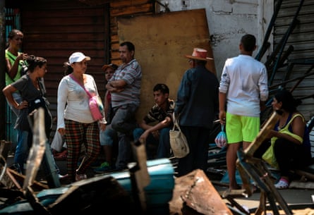 Locals sit on the street during the blackout in Maracaibo.