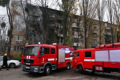 Firefighters work to put out a fire in a residential building hit by a Russian strike in Kyiv.