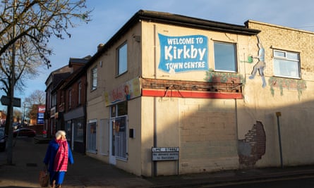 'Welcome to Kirkby town centre' is written on a mural on the side of a two-storey building
