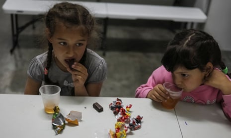 Eva, 8, and Violetta, 7, eat candies and drink tea at a refugee shelter for children in Zaporizhzhia, Ukraine May 16, 2022.