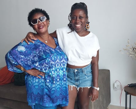 Two women smile and pose for the camera.