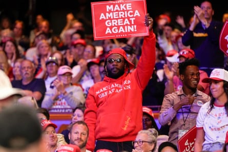 The Long Wave: Unearthing the real story of Black voters at the US election A Black man wearing a red Maga outfit and holding aloft a placard that reads: ‘Make America great again!’ stands amid a crowd of mostly white people