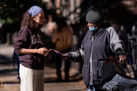 Canvasser Asa Kohrman speaks with a passerby about voting for Zohran Mamdani