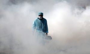 A worker sprays disinfectant in a deserted market in Jammu, India.