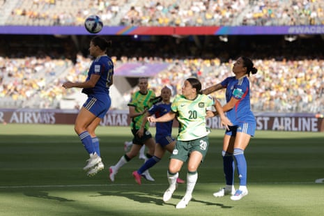 Angie Beard clears the ball under pressure from Sam Kerr.