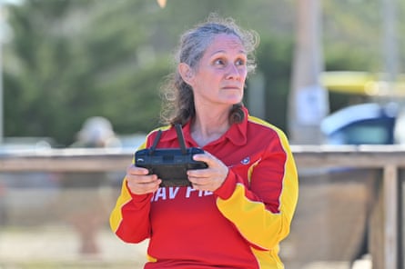 A lifeguard operates a UAV (unmanned aerial vehicle, or drone) to patrol the waters at Dee Why beach in NSW.