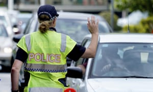 A police officer stops a driver at a checkpoint at Coolangatta