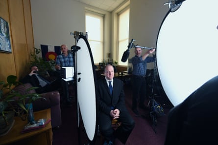 Governor Jared Polis filming a video message for an upcoming event in an office at the statehouse.