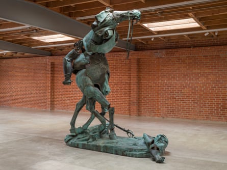 A green, oxidized bronze sculpture whose figures have been cut up and reassembled.