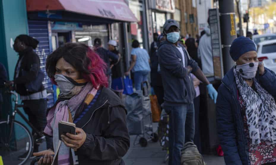 People wear an assortment of face masks on Walworth Road, London, in April.
